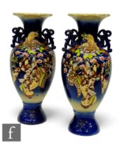 A large pair of 20th Century Japanese satsuma vases, all over decorated with flowers and figures