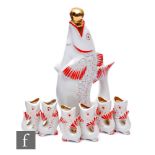 A 1960s USSR vodka decanter in the form of a fish and a set of six matching shot glasses, red and