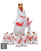 A 1960s USSR vodka decanter in the form of a fish and a set of six matching shot glasses, red and