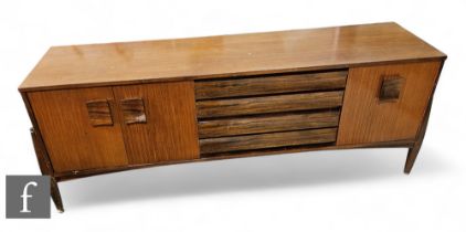 A post 1950s teak G plan sideboard, the centre section fitted with four drawers flanked by cupboards