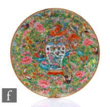 A 19th Century Cantonese famille rose patterned plate, centred with a white vase and decorated