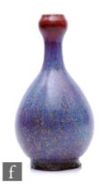 A Chinese Junyao style purple splashed vase, of bottle form rising to a garlic-head rim, height