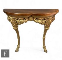 A small 20th Century Regency style gilt consul table, mahogany top over a pierced ram's head, height