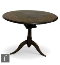 A George III oak circular tripod occasional table with a bird cage movement and an Art Nouveau