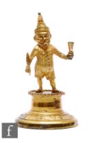 A 19th century gilt table lighter modelled as Mr Punch smoking a cigar and holding a feathered