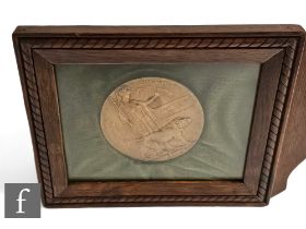 A World War One death plaque awarded to Alfred William Spencer, framed.