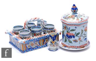 A late 19th Century French Faience ware egg cup set by Desvres Fourmaintraux, the rectangular