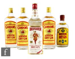 A collection of gins, 1980s bottling, to include a 1 litre Beefeater, three 1 litre Gordon's and a