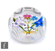 A later 20th Century Perthshire glass paperweight, of domed form with facet cut sides and top,