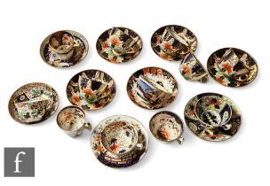A collection of 19th Century Staffordshire cups and saucers all in variants of the Imari design in a