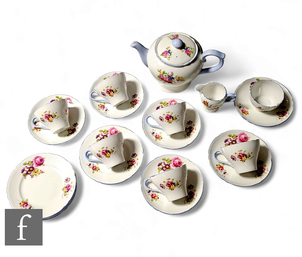 A Shelley New Cambridge shape teaset decorated with a floral spray including roses and blue banding,