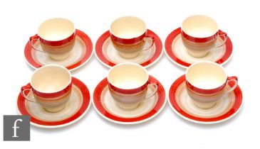 A set of six 1930s Susie Cooper coffee cans and saucers, hand painted with tonal red, brown and grey