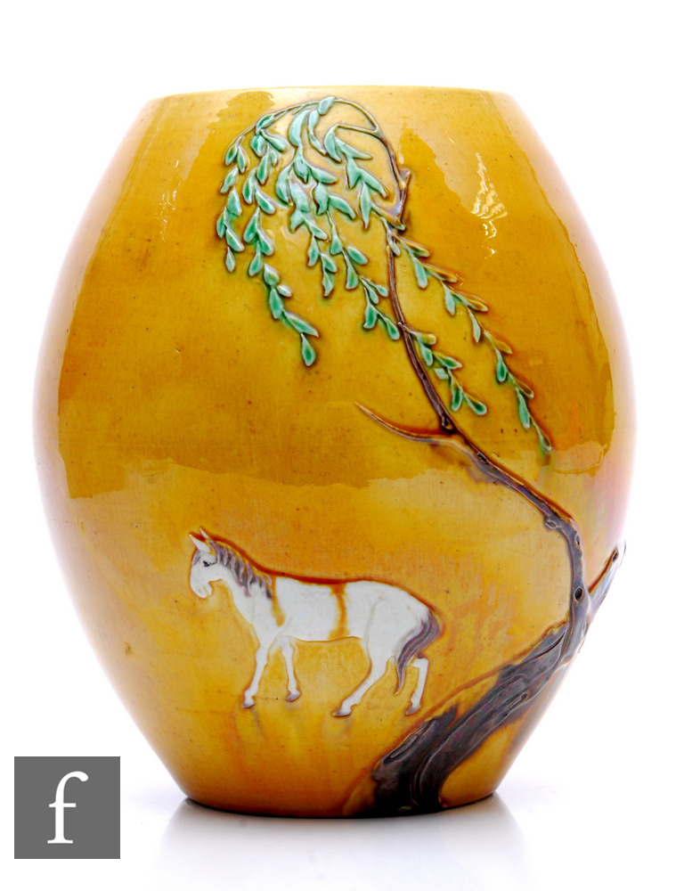 A Chinese Sancai glazed ovoid form vase, relief moulded with horse before a willow tree, before a