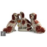 A large pair of 19th Century seated Staffordshire Spaniels picked out in rust red flash with gold