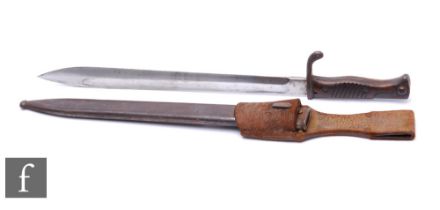 A World War One German bayonet, 37cm blade, with metal scabbard and leather holder, marked A-G