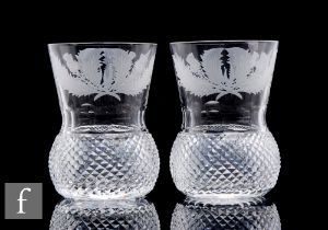 A pair of 20th Century Edinburgh Crystal thistle form whisky glasses with engraved thistle