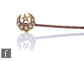 A gold and seed pearl set crescent moon stick pin, with solitaire diamond set star.