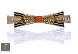 An Art Deco brooch in the form of a bow, inset with enamel and paste stones.