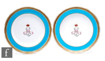 A pair of late 19th Century Minton porcelain plates, each decorated to the central well with a