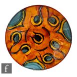 A large later 20th Century Poole Pottery wall plaque or charger of shallow circular form,
