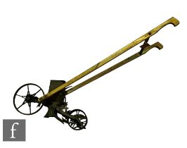 A 19th Century push along seed drill, Planet No 25, iron spoked wheels and elm shaft handles, length