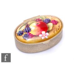 A contemporary oval pill box inset with a hand painted oval tablet depicting a fallen fruits scene