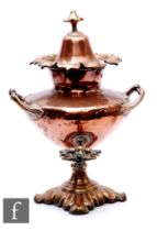 A 19th Century copper two handled samovar of urn form with cover and tap, on a foliate base,