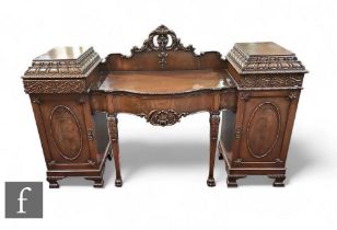 An Edwardian carved mahogany pedestal sideboard, the serpentine front with a frieze drawer flanked