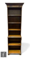 An Edwardian style mahogany bookcase of narrow proportions, dentil fluted cornice over and