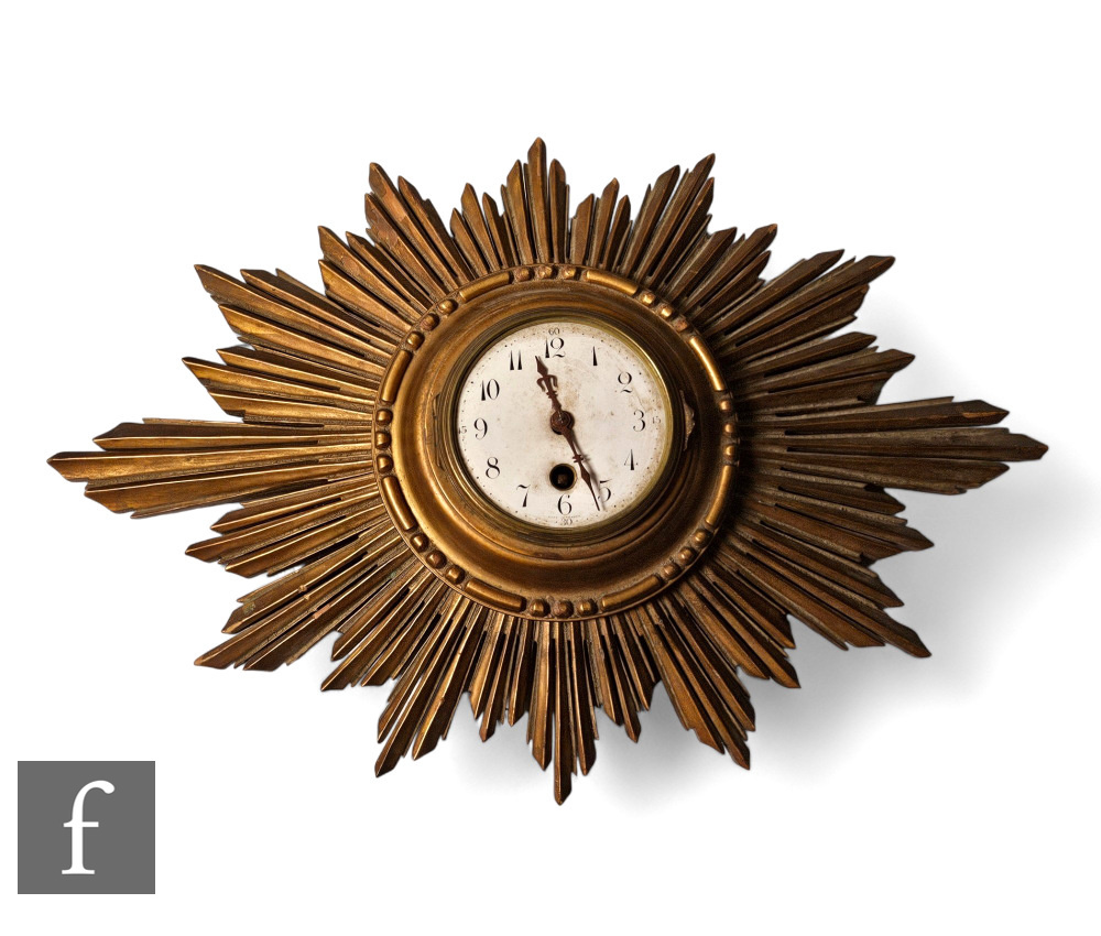 A 1920s French gilt sunburst wall clock, white circular dial, width 46cm.
