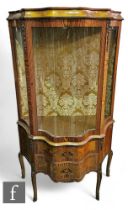 A late 20th Century Louis XIV style floral marquetry inlaid display cabinet of serpentine out