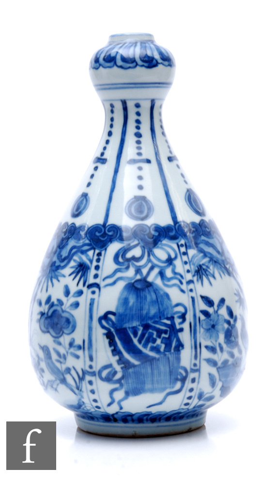 A Chinese Wanli style blue and white garlic head vase, decorated with segmented panel,