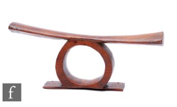 A 19th Century hardwood African Ivory Coast head rest, some old losses, width 47cm.
