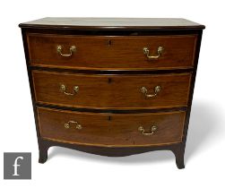 A George III mahogany bowfront chest of three satinwood crossbanded and line inlaid drawers, brass
