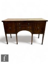 An early 20th Century Regency style mahogany sideboard, fitted with two short drawers and flanked by