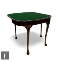 A Queen Anne style figured walnut fold over card table, the moulded edge shaped top over a plain