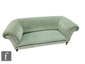 An Edwardian scroll arm two seater Chesterfield settee on small square mould legs to the front,