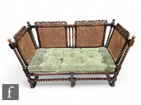 A 1920s three seater bergere style settee, single cane side, on spiral block legs, width 146cm.