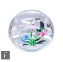 A contemporary Allan Scott glass paperweight, of domed form with facet cut sides and top, in the