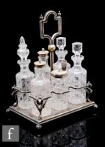 A 19th Century condiment set with six clear crystal glass bottles with cut decoration to a silver