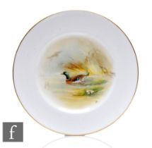 A 20th Century Royal Worcester porcelain plate of circular form, the central well hand enamelled