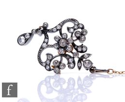 A late 19th Century open work old cut diamond set pendant/brooch with central seven stone daisy