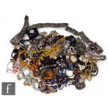 A parcel lot of assorted costume jewellery to include beads, brooches, bracelets, pendants, clips