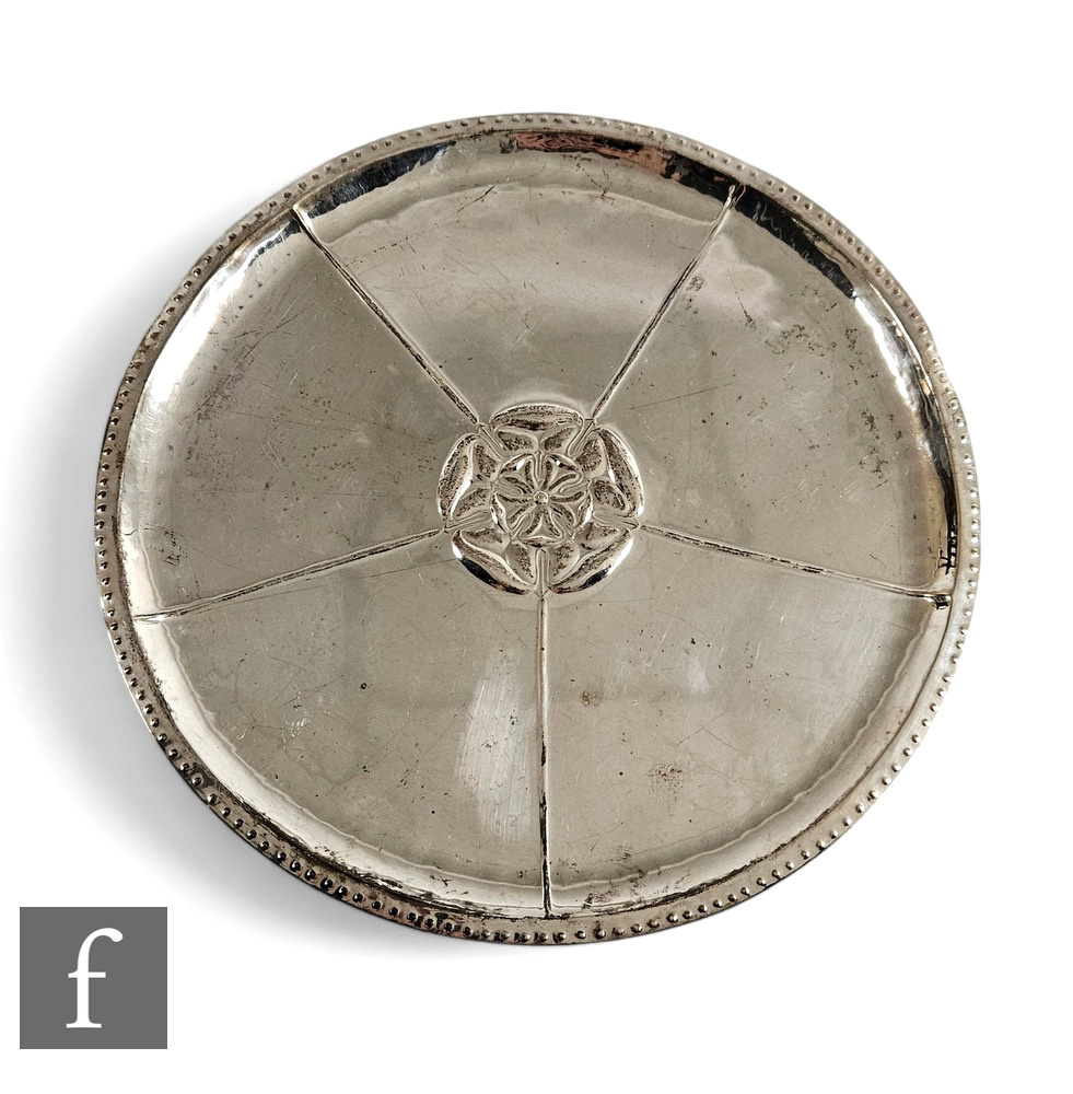 A hallmarked silver circular platter with central Tudor rose decoration within beaded borders,