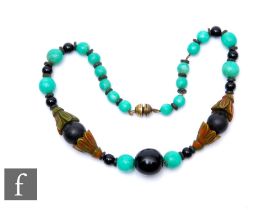An early 20th Century jadite, black onyx and phenolic chain threaded necklace, weight 72g, length