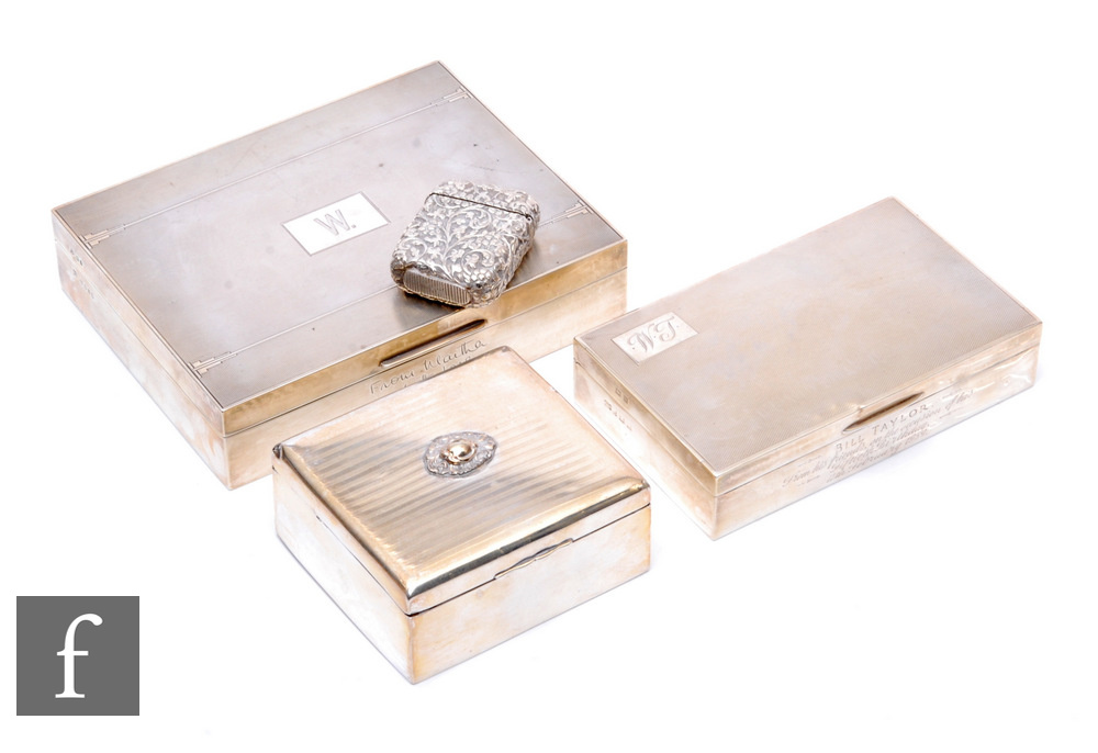 Three hallmarked silver cigarette boxes each with engine turned decoration, largest 17cm x 13.5cm,