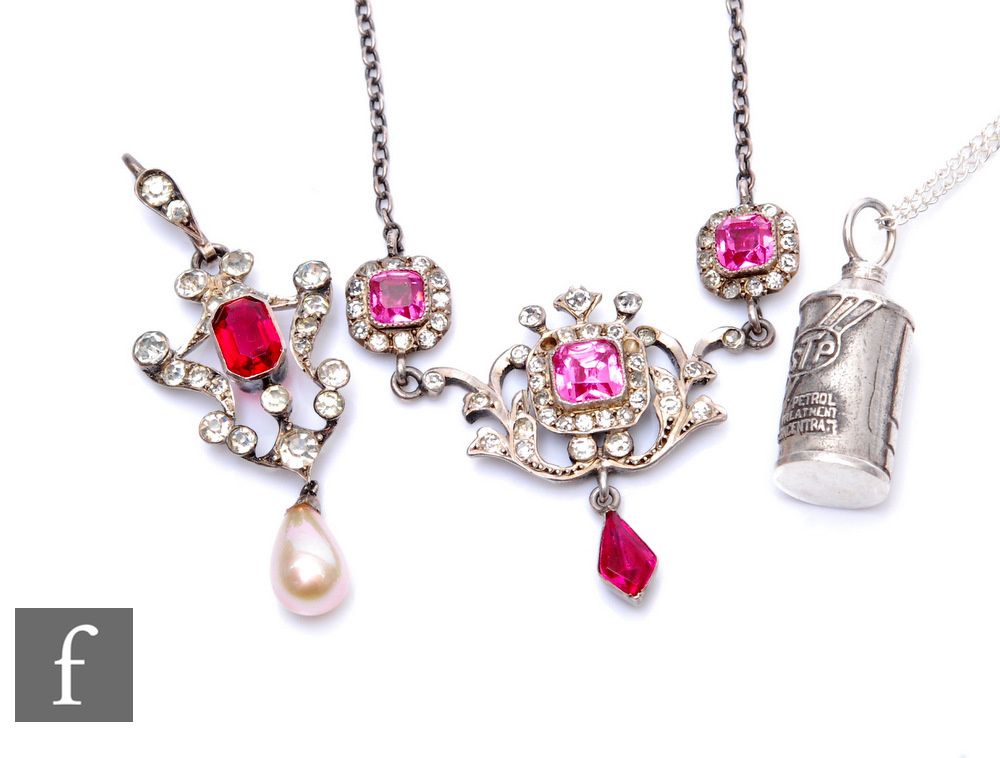 Two 19th Century white metal paste set pendants with red and white stones, with a later