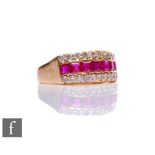 An 18ct ruby and diamond ring, a central row of seven square rubies flanked above and below by a row