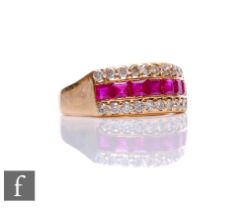 An 18ct ruby and diamond ring, a central row of seven square rubies flanked above and below by a row