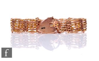 A 9ct rose gold six bar fancy link gate bracelet weight 24g, terminating in padlock fastener.